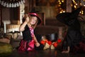 Two little witches in costumes and hats conjure pot, childhood Royalty Free Stock Photo