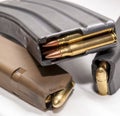 Two loaded 9mm pistol magazines with a loaded 223 caliber magazine Royalty Free Stock Photo