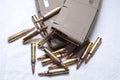 Two loaded .223 rifle magazines with bullets laying around them Royalty Free Stock Photo