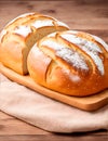 Two loafs of bread on a wooden kitchen board