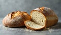 Two Loaves of Bread, One Sliced, on Gray Surface Royalty Free Stock Photo