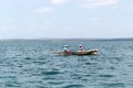 Two local fishermen in a small wooden boat in the Indian Ocean, Tanzania Royalty Free Stock Photo