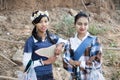 Two local girls are standing and welcome tourist .