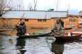 Two local men rowing shikaras on Dal Lake, Srinagar, Kashmir