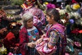 Two local women wearing traditional clothing in a street market in the town of Chichicastenango, in Guatemala