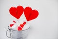 Two Lollipops heart shaped in Small bucket with sweets on white Royalty Free Stock Photo