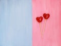 Two lollipops on pink and blue background. Love concept. Valentines day