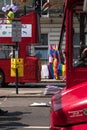 Two London double decker buses parked on Regent Street before the Gay Pride Parade 2018. Colourful LGBT rainbow flags can be seen.