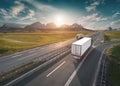 Two lone white trucks on highway at idyllic sunny morning Royalty Free Stock Photo