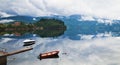 Two lonely boats on calm water of fjord, Norway