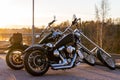 Two long fork chopper Harley Davidson motorcycles side by side in the evening sun Royalty Free Stock Photo