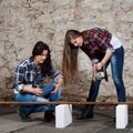 Two long-haired young woman with an angle grinder Royalty Free Stock Photo