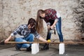 Two long-haired young woman with an angle grinder Royalty Free Stock Photo