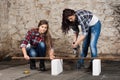 Two long-haired young woman with an angle grinder Royalty Free Stock Photo