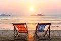 Two lounge chairs on sunset beach. Relax. Royalty Free Stock Photo