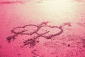 Pink two love heart sign with cupid arrow hand draw on the beach Royalty Free Stock Photo