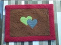 The two love symbol foot mat in the middle is green and blue