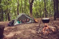 Two lovely couples lying down in the tent in a campground, so ha