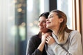 Two lovely girls in a cafe. Female friends hugging and looking outside the window