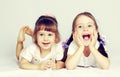 Two lovely little girls playing on the floor Royalty Free Stock Photo