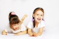 Two lovely little girls playing on the floor Royalty Free Stock Photo