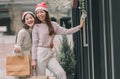 Two women doing window shopping and holding bags in christmas season Royalty Free Stock Photo