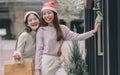 Two women doing window shopping and holding bags in christmas season Royalty Free Stock Photo