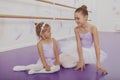 Charming two young ballerinas practicing at ballet class