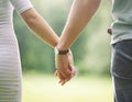 Two lovers gently holding each other`s hands and walking in the Royalty Free Stock Photo