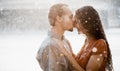 Two lovers kissing under summer rain Royalty Free Stock Photo
