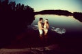 Two lovers in a lake at night. Girl and man at sunset in the lake.