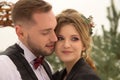 Two lovers, a man and a woman, a wedding in winter. bride and groom love. against the backdrop of decor and trees, snow. holding a Royalty Free Stock Photo