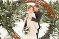 Two lovers, a man and a woman, a wedding in winter. bride and groom love. against the backdrop of decor and trees, snow. holding a Royalty Free Stock Photo