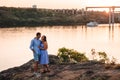 Two lovers people at sunset by the river