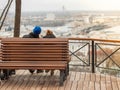 Two lovers, in a romantic setting, admire the view of the city landscape