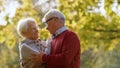 Two loving grey-haired people together outdoor in autumn nature