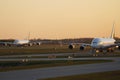 Two Lufthansa airplanes taxiing, Airbus A380 and a small aircraft