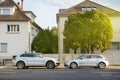 Two luxury AUDi cars parked in front of the large houses Royalty Free Stock Photo