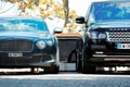 Two Luxury English Cars Parked in a Parking Lot