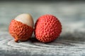 Two lychee fruits wooden background Royalty Free Stock Photo