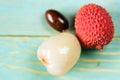 Two lychee fruits and seed wooden background Royalty Free Stock Photo