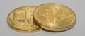 two lying bitcoins with front and back side view on gray panorama