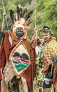 Two Maasai with his face painted