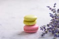 Two macarons and bunch lavender on white natural marble table