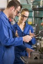 Two machinists working on machine Royalty Free Stock Photo