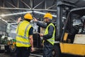 Two maintenance engineers inspect system with computer. They work industry factory