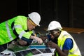Two maintenance engineers Solar energy systems engineer perform analysis solar panels. Royalty Free Stock Photo