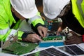 Two maintenance engineers Solar energy systems engineer perform analysis solar panels.