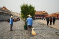 Two maintenance workers having a conversation in the Forbidden City area