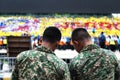 Malaysian army men watching students practicing for Hari Merdeka in Malaysia, Kuala Lumpur